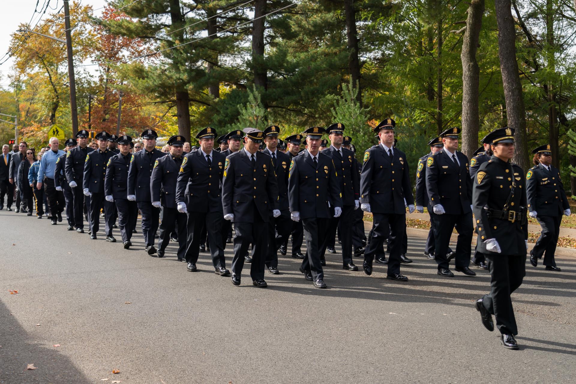 Image of walking procession at Chief DeVaul's funeral.