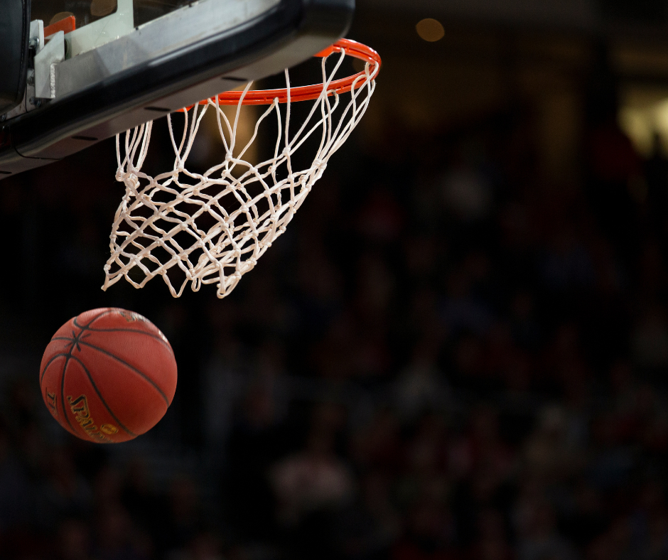 Close-up of a basketball going through a basket.